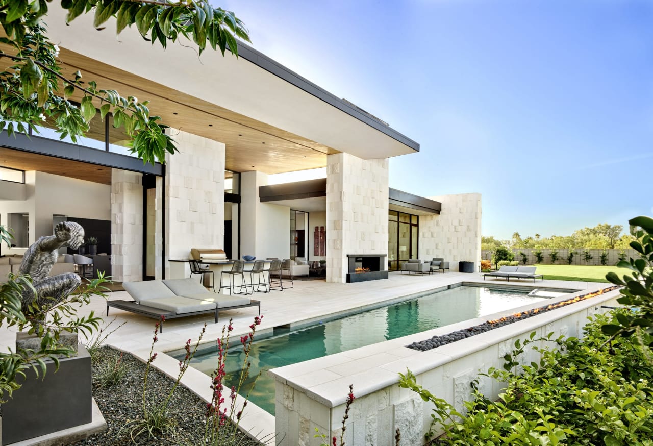 Modern estate with angled pool and white stone