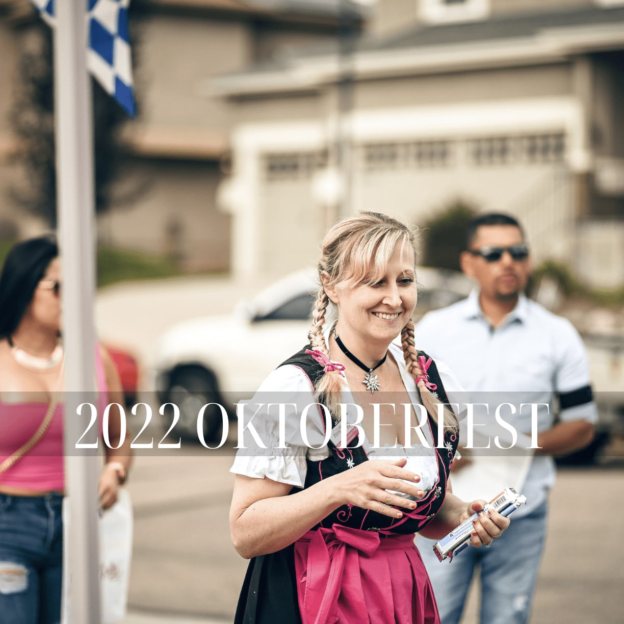 A woman in Oktoberfest attire smiles while holding a drink, with the text '2022 OKTOBERFEST' overlayed on the image.
