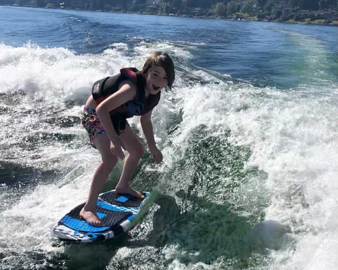 a kid riding on a blue waveboard