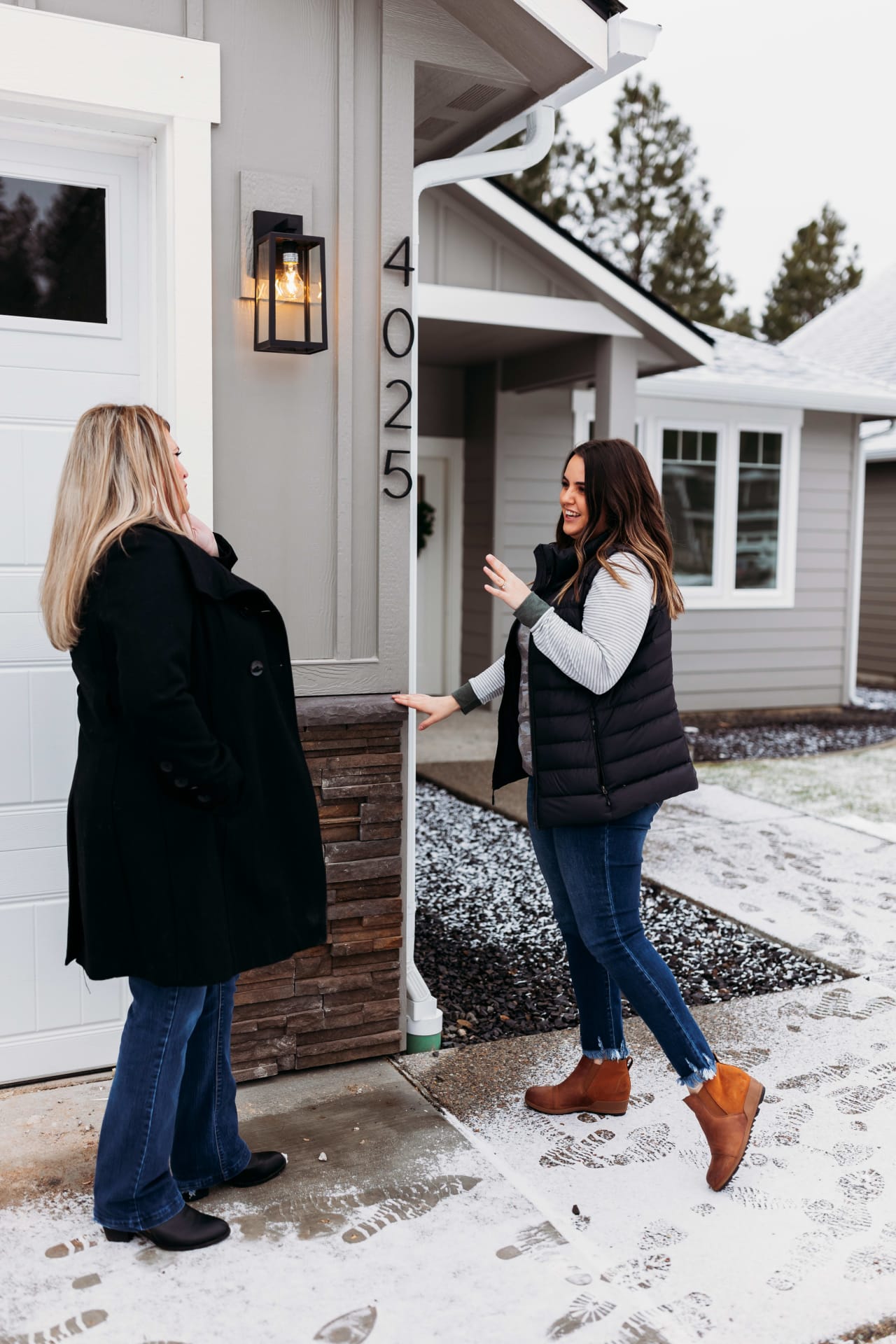 Samara Behler helps prospective buyer view a home during Spokane winter.