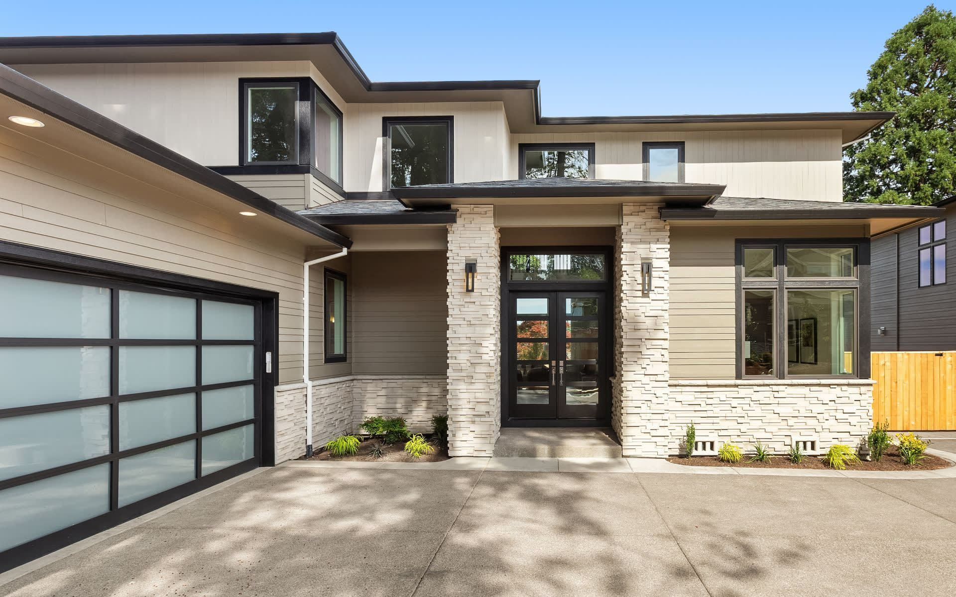 The house has several dark-framed windows of various sizes