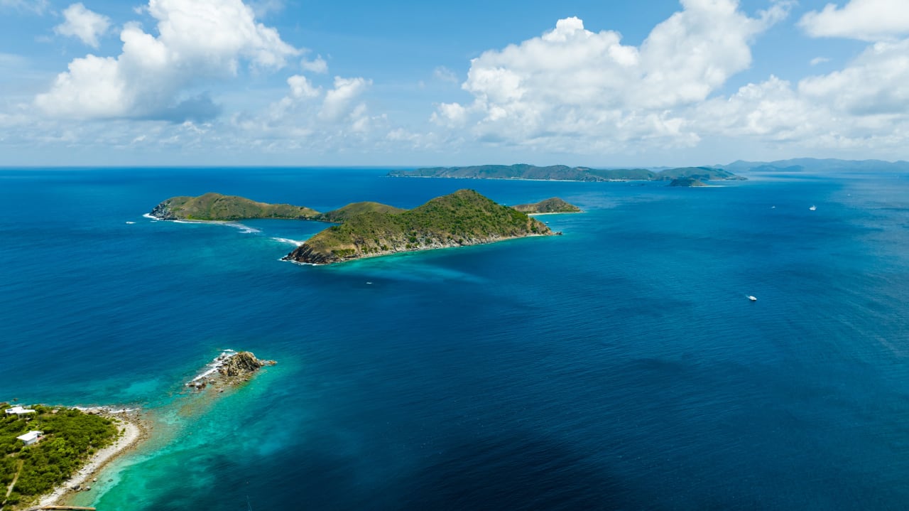 An aerial view of a group of islands in a turquoise ocean