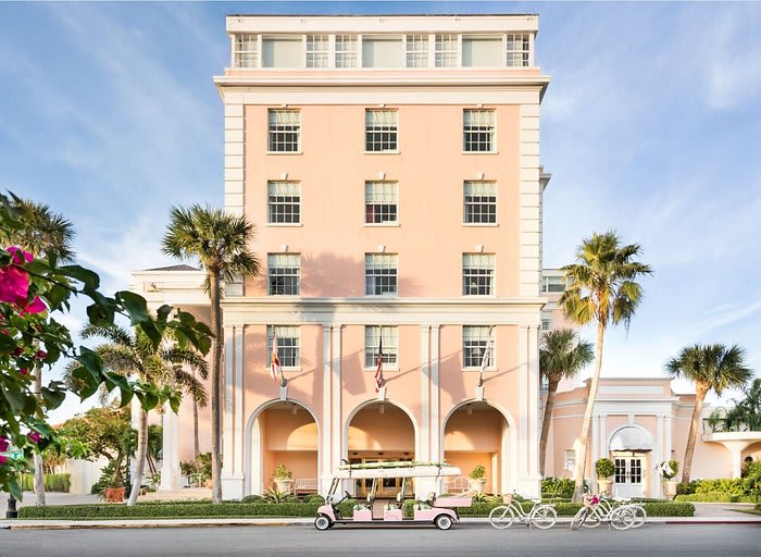 Front of Colony Hotel - pink with bikes and golf cart