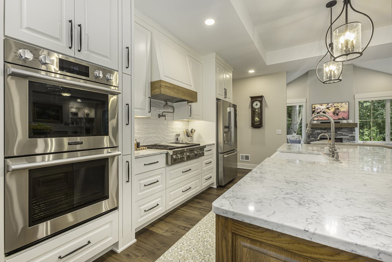 white kitchen space with granite top counter