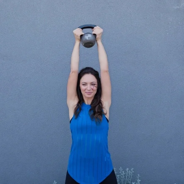 Cat holding kettlebell