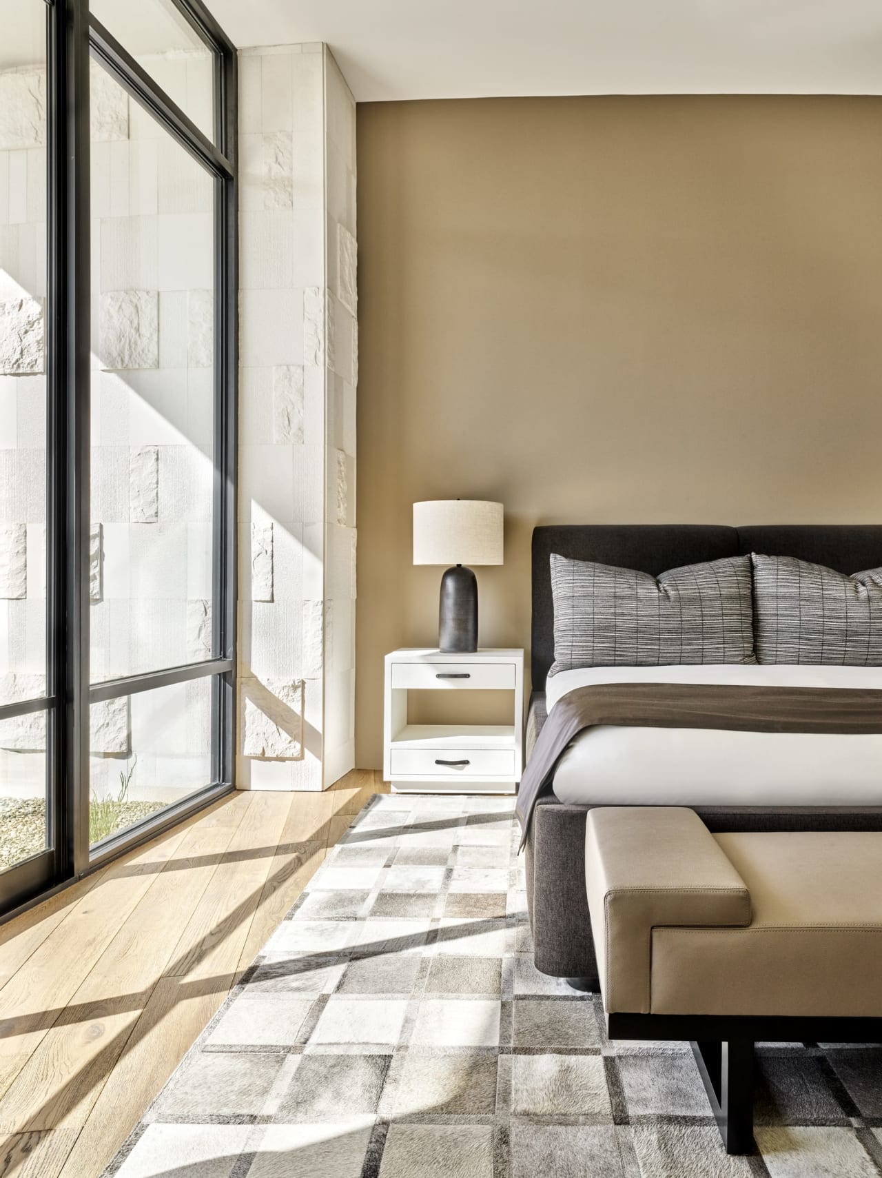 Bedroom with limestone walls in luxury residence