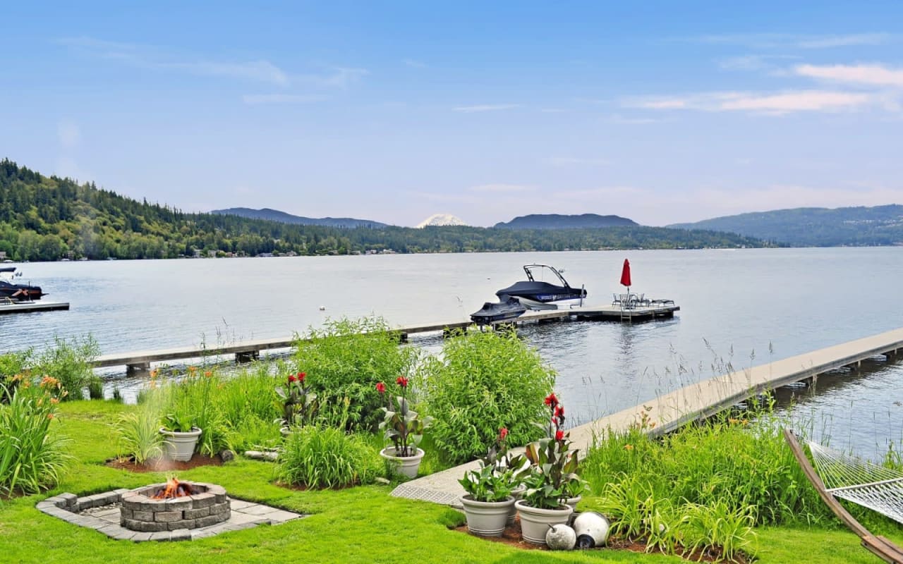 a nice garden with fireplace near a boat dock