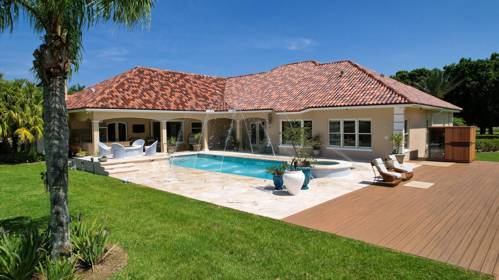 Backyard saltwater pool and covered lanai of a Vero Beach acreage estate