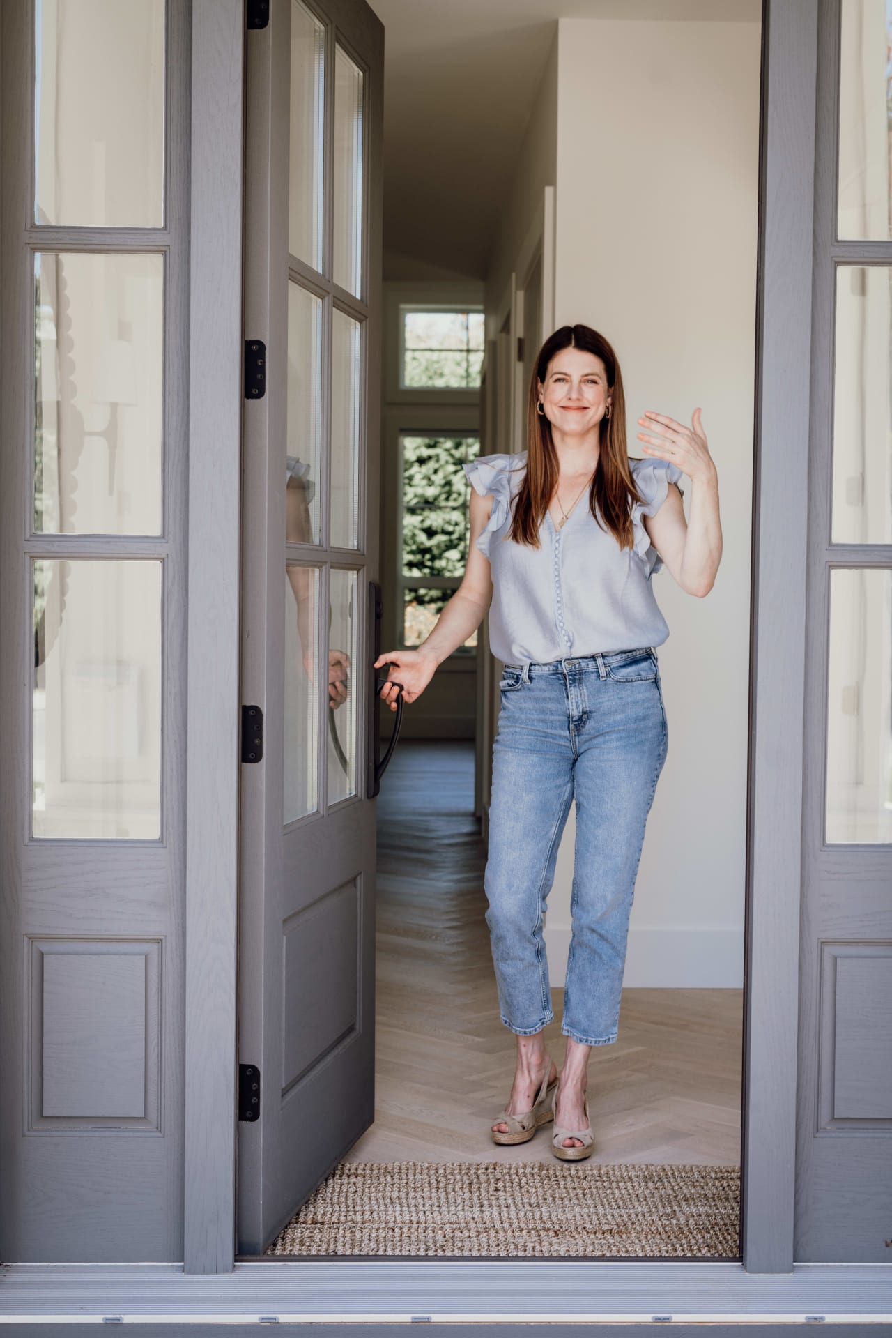 Realtor welcoming clients to open house