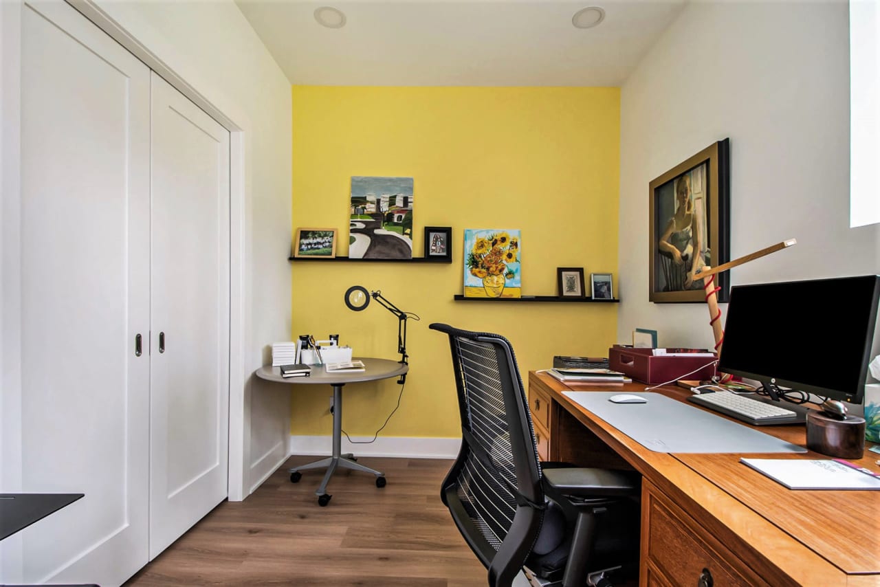 small office area with wooden table and personal computer