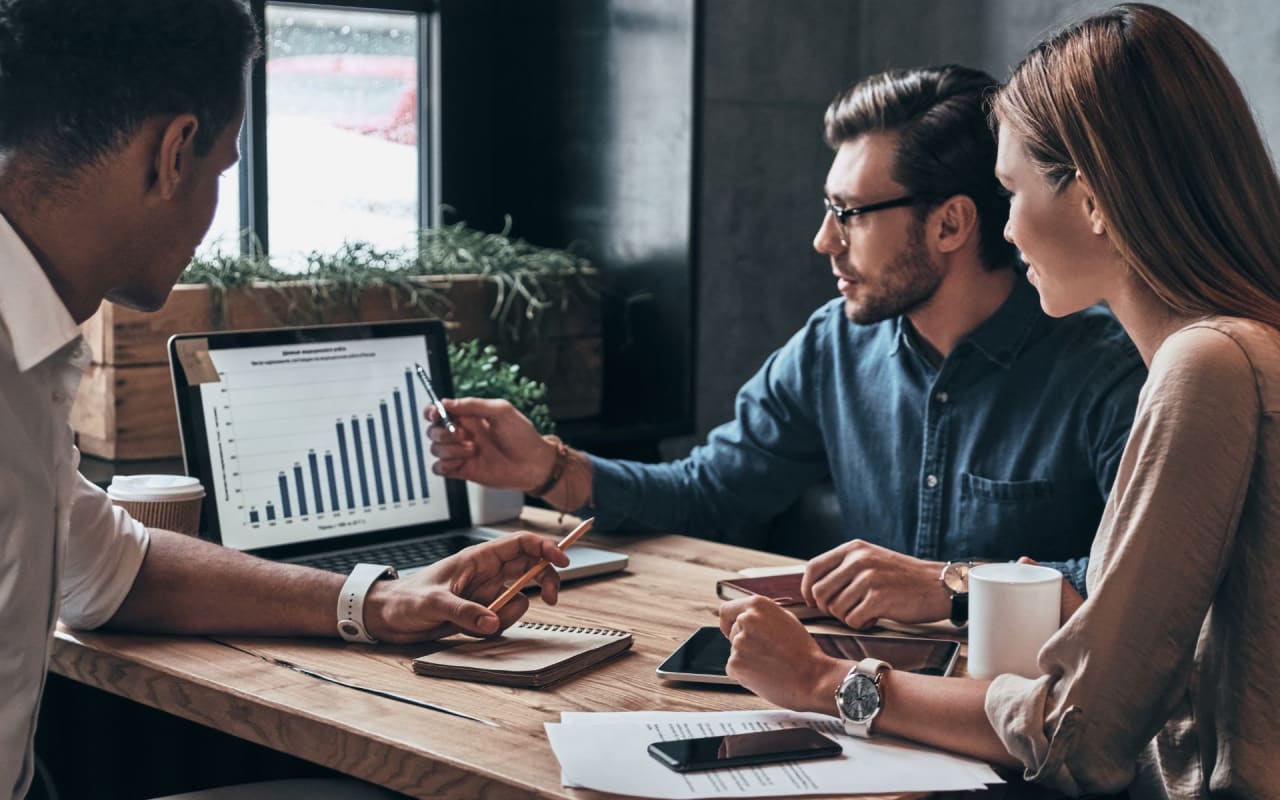 three people discussing about the data report