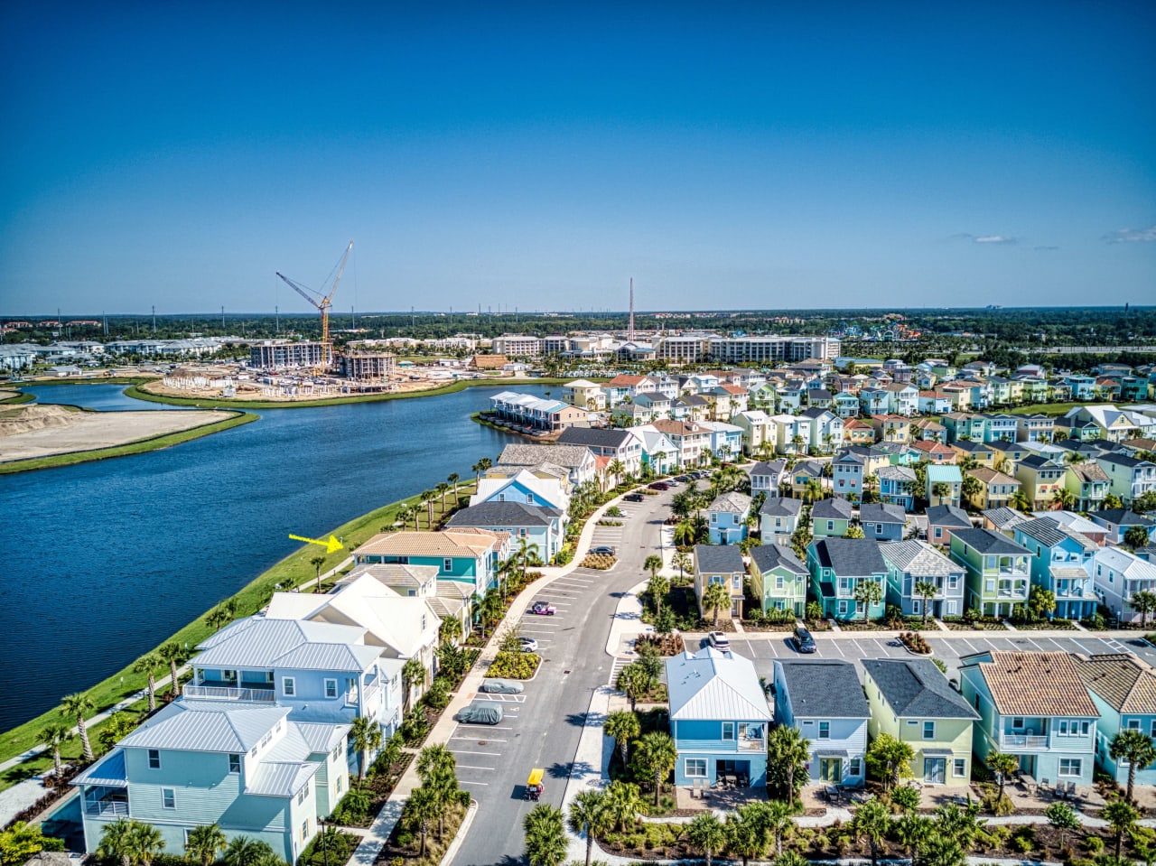 An aerial view of a residential neighborhood next to a body of water.