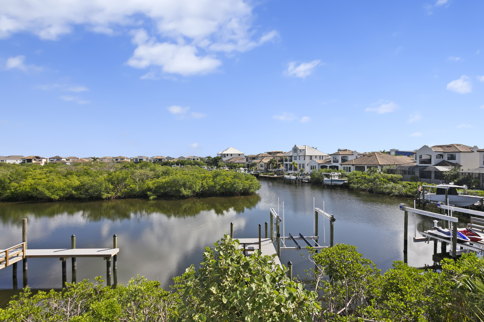 Waterfront Tampa neighborhood with private docks, boat lifts, mangroves, and homes set along a protected channel.