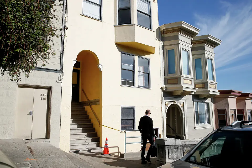 A man walks past a building with TIC occupancy on Vallejo Street in San Francisco