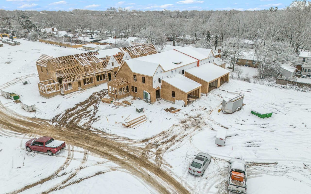 A house under construction in a winter landscape