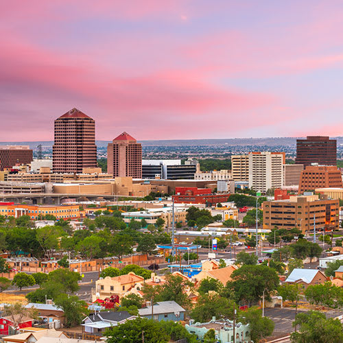 An aerial view of a city skyline at sunset.