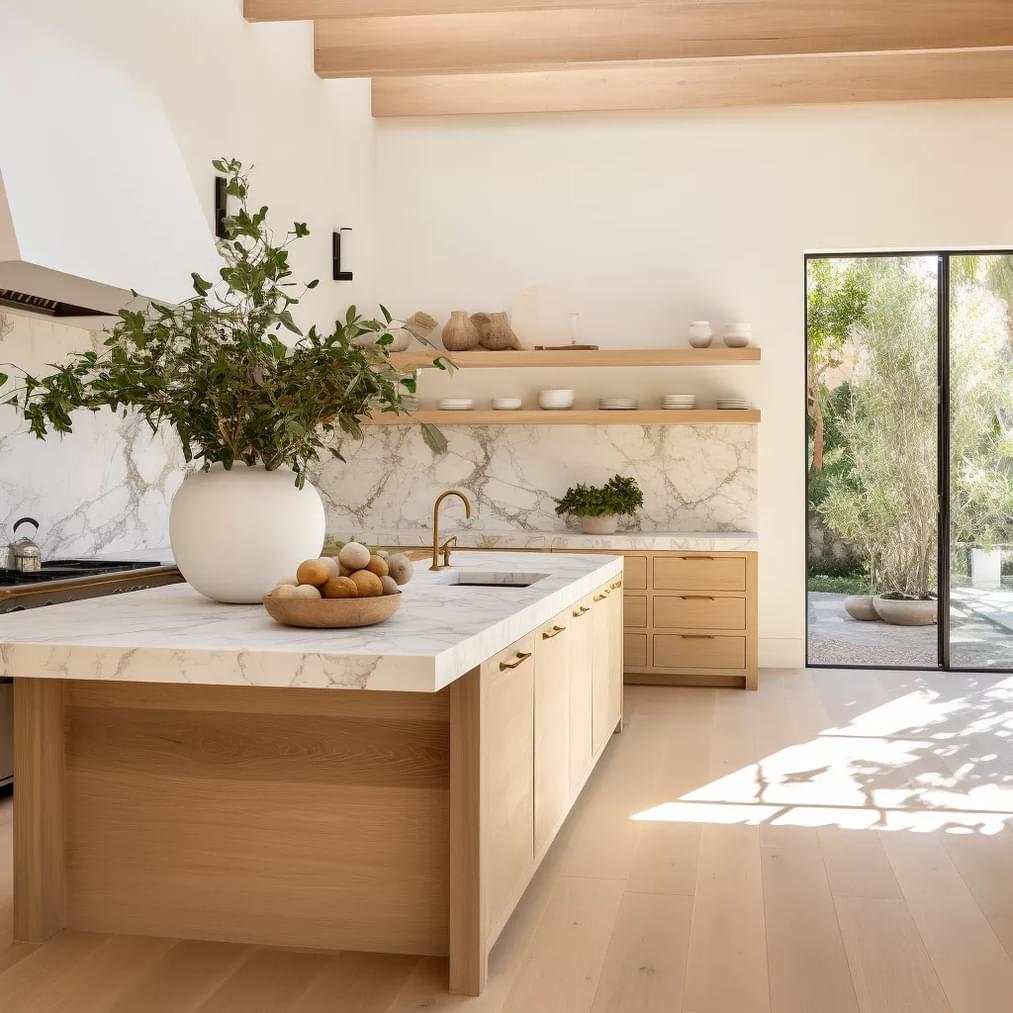 A kitchen with marble countertops and wooden cabinets.