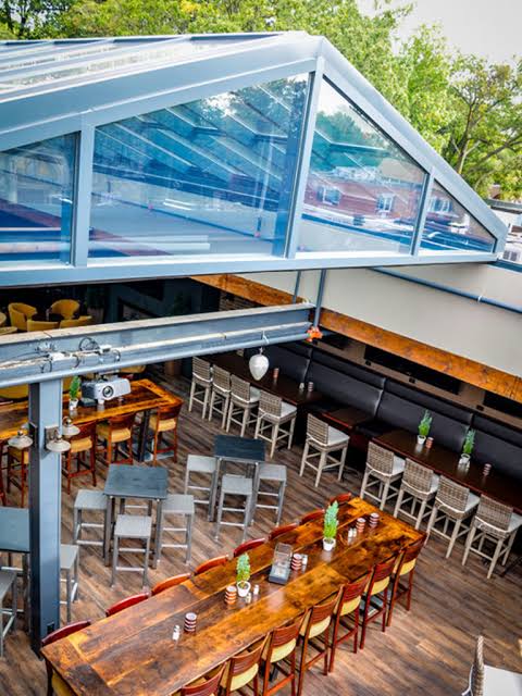 Under the retractable glass roof on the rooftop patio at The Crooked Cue