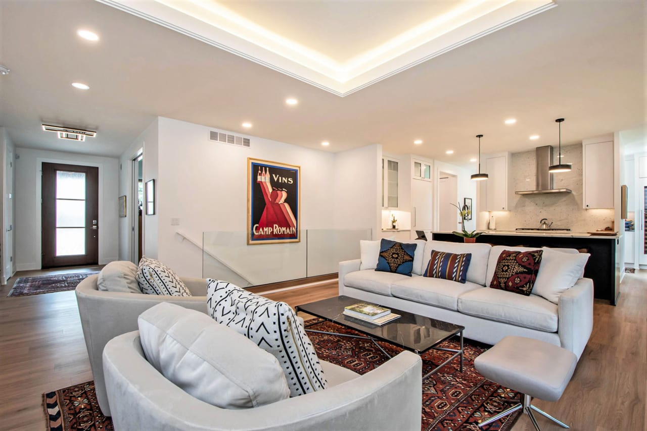 beige couches in a living room near the door