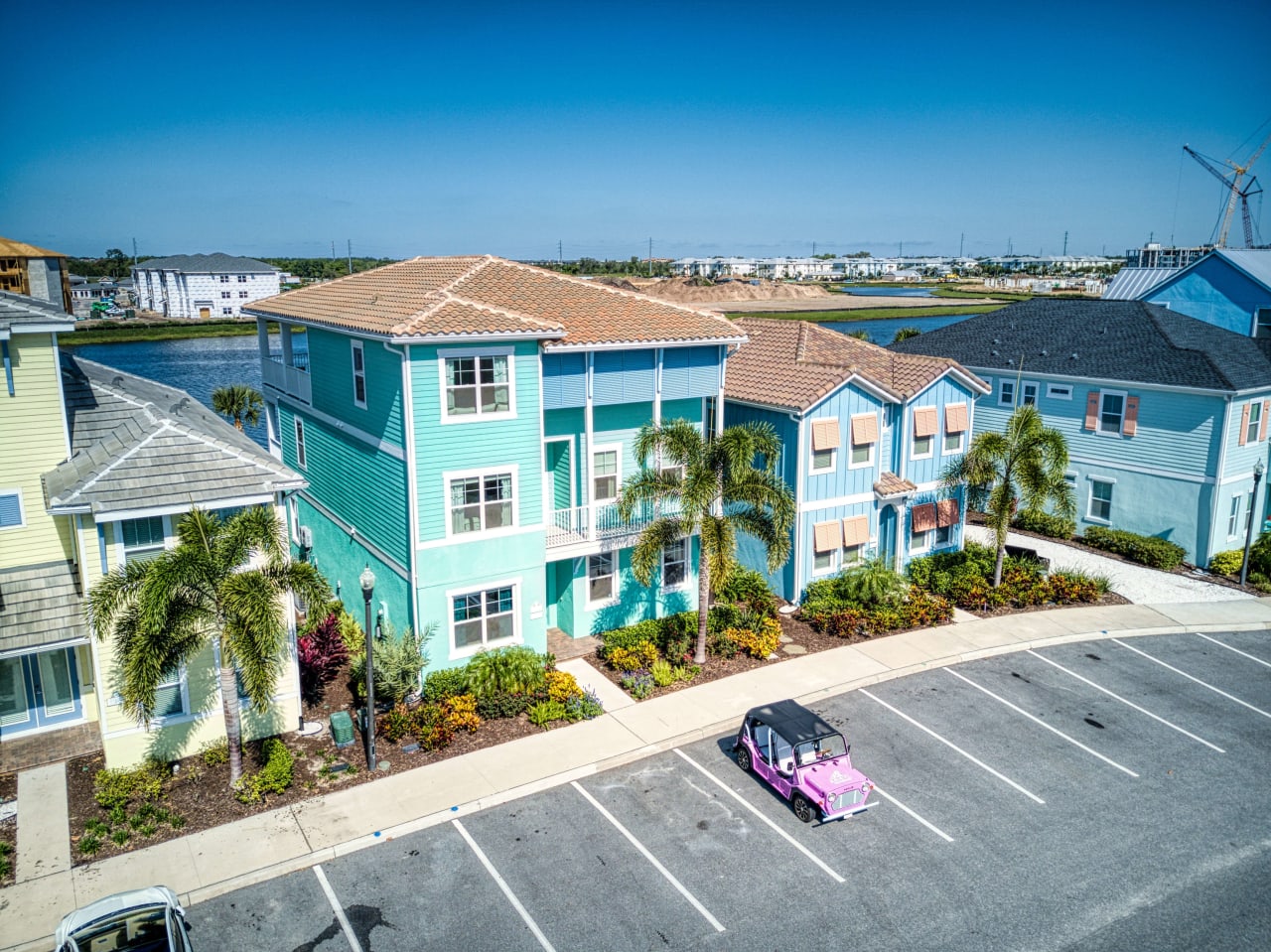 An aerial view of a row of colorful houses in a residential neighborhood.