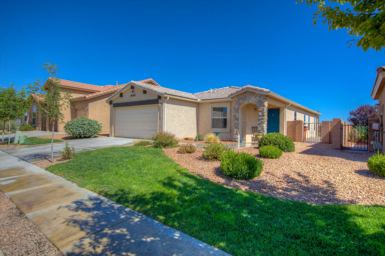 A large house with a lush green lawn in front of it.