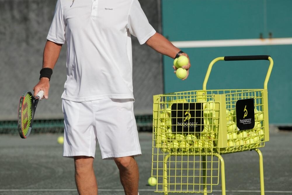 Tennis professional feeding balls during a clinic on the Har-Tru courts at Sea Oaks Vero Beach