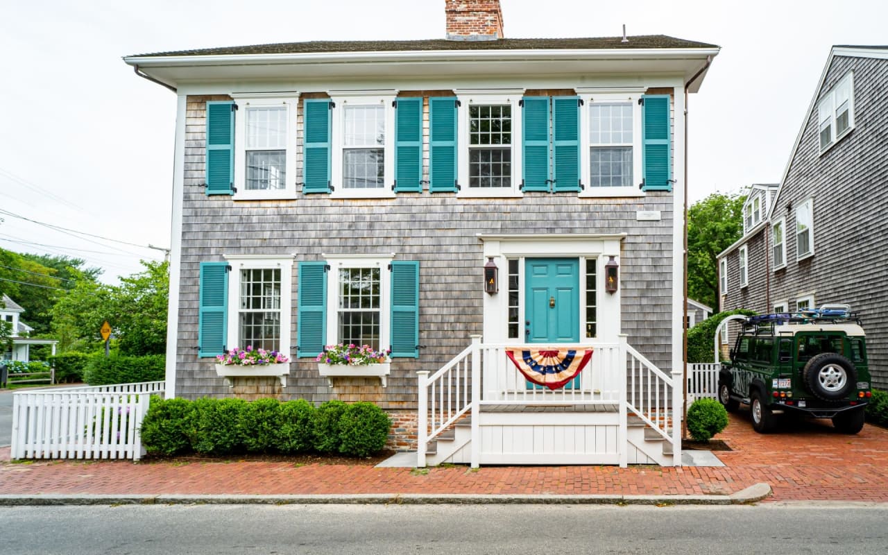 A house with a blue door and blue shutters.