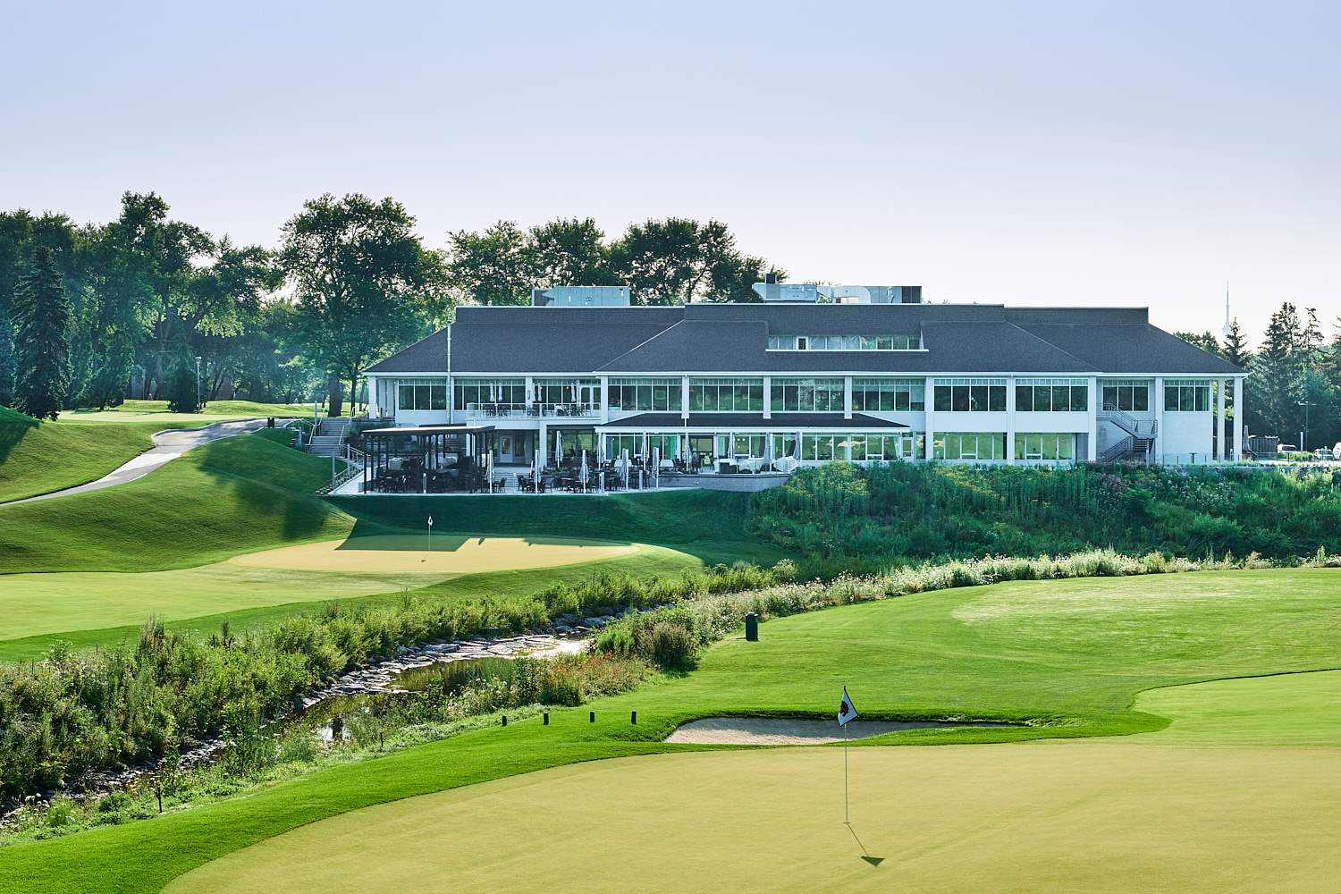 The Islington Golf Club clubhouse and patio seen from the course