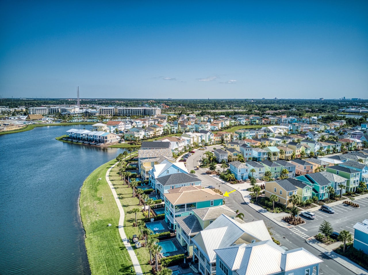 An aerial view of a residential area along a lake. 