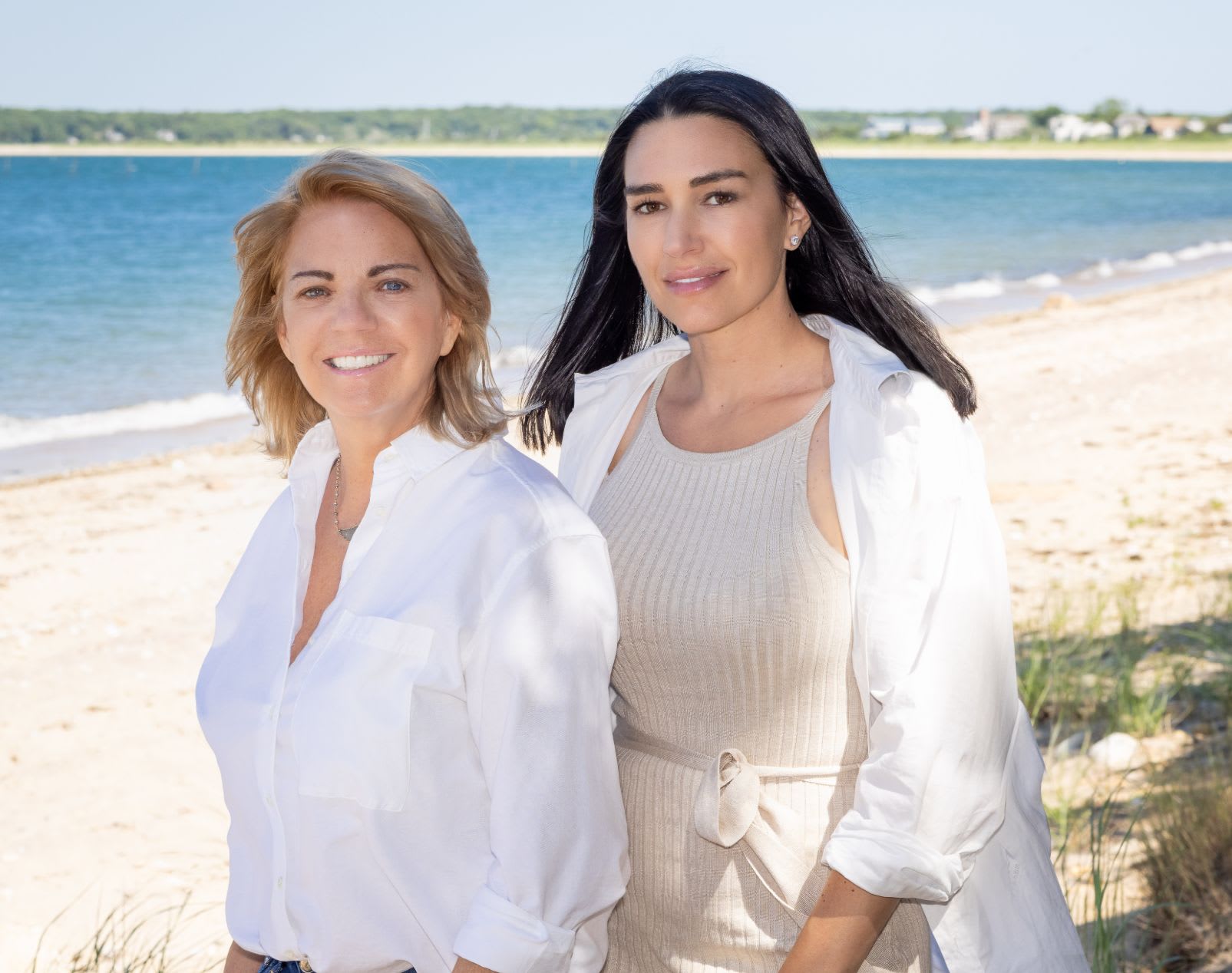 Real estate experts Lori Schiaffino and Niki Mabey on a beach