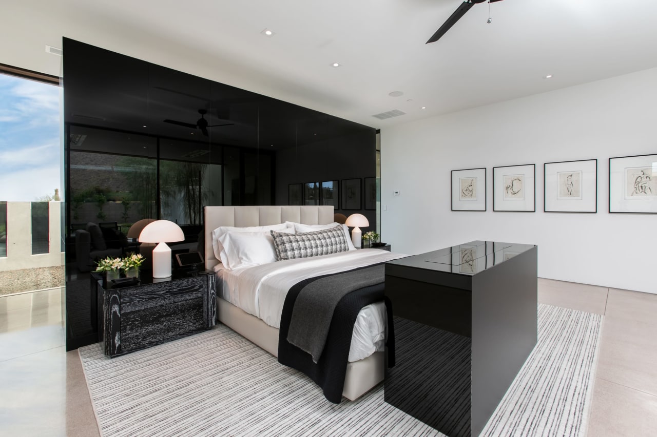 Luxury home with modern primary room and black accents