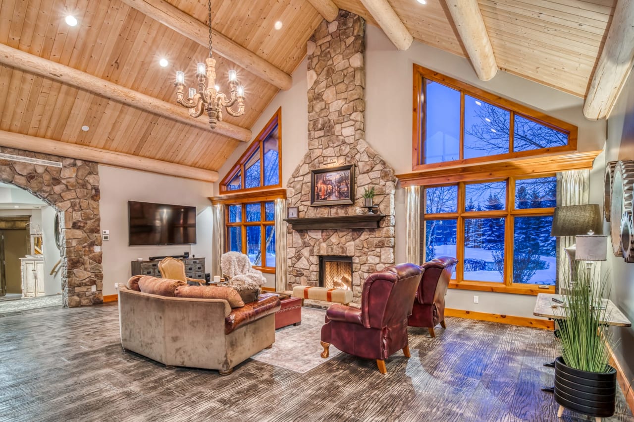 A large living room with a stone fireplace