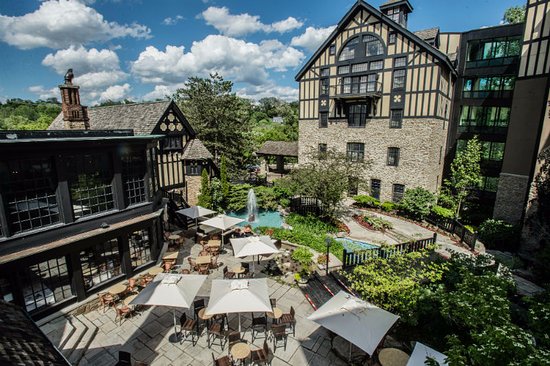 The courtyard patio at the Old Mill Toronto with umbrellas and the fountain