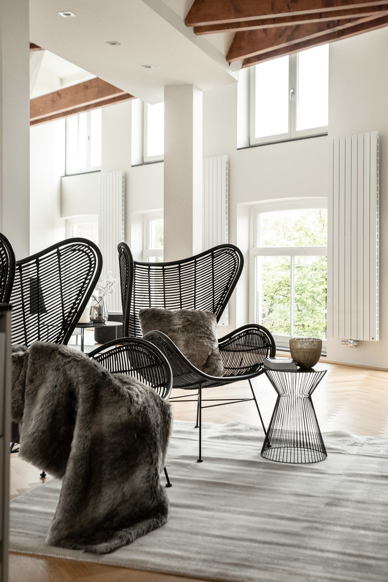 A still life of two chairs and a table arranged in a living room setting.