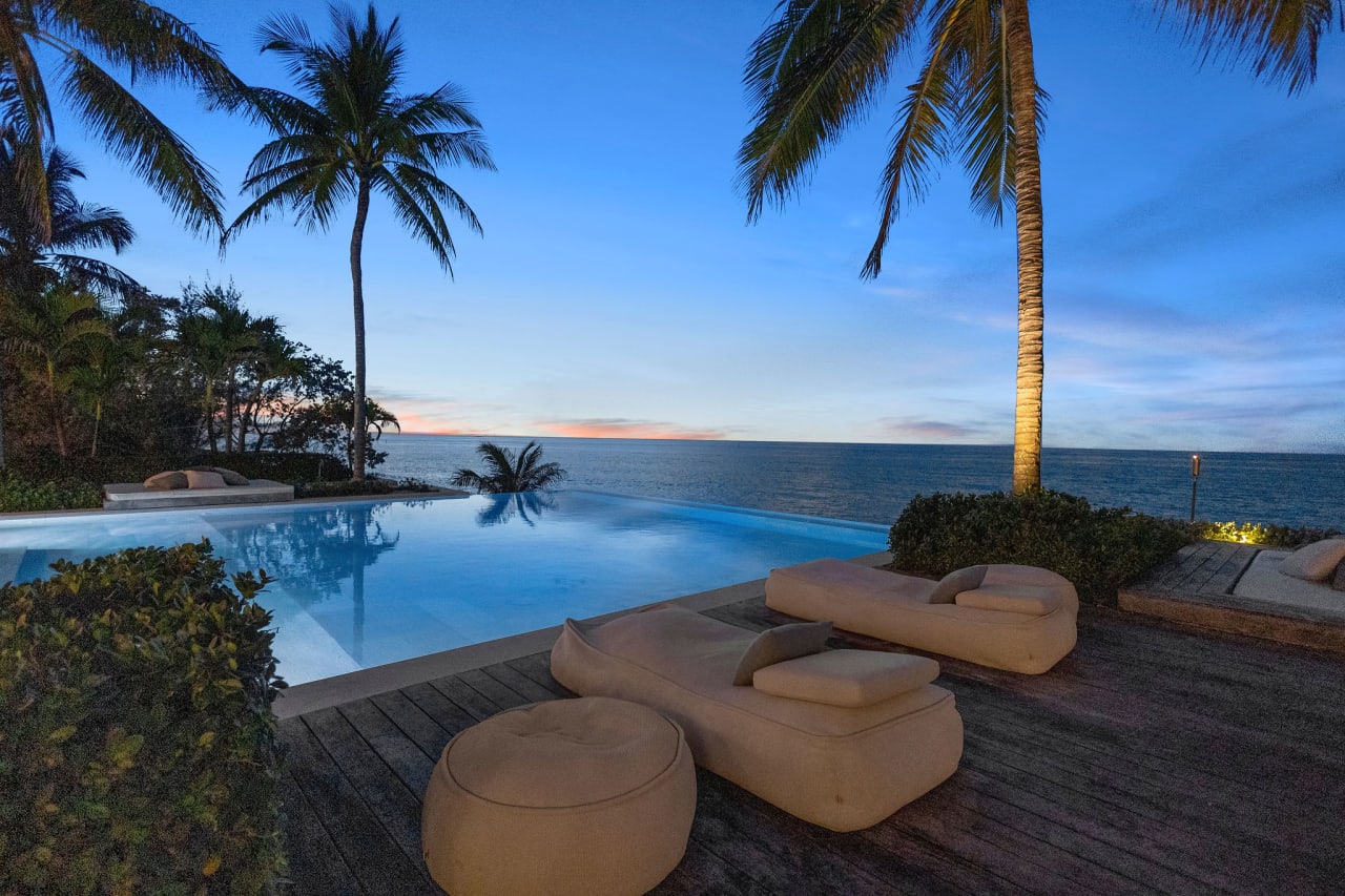 A swimming pool with a refreshing view of the ocean