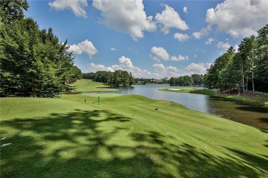 Golf course with a lake in the background, sunny day.