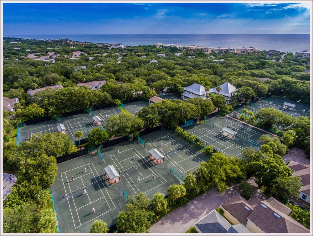 Aerial view of Har-Tru tennis courts under oak canopy at Sea Oaks