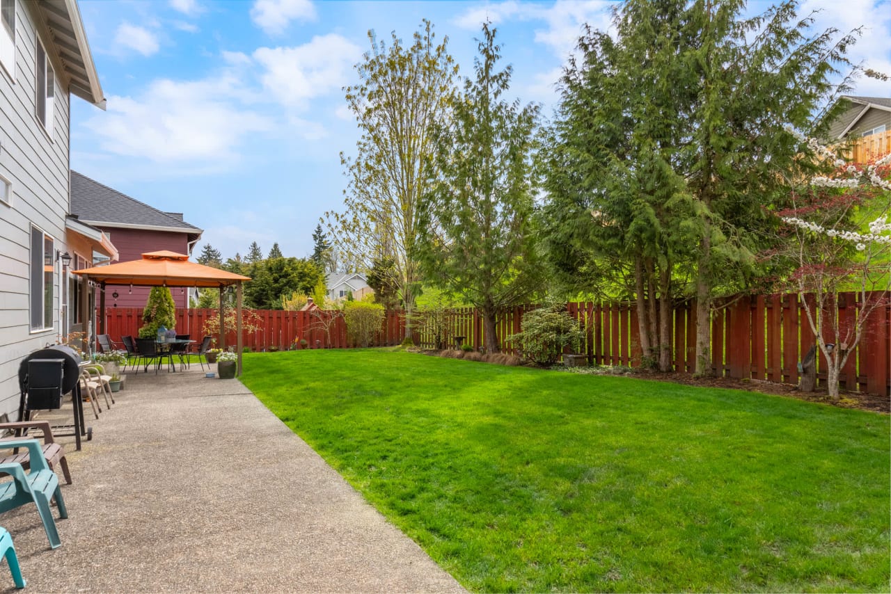 A well-maintained backyard with a lush green lawn