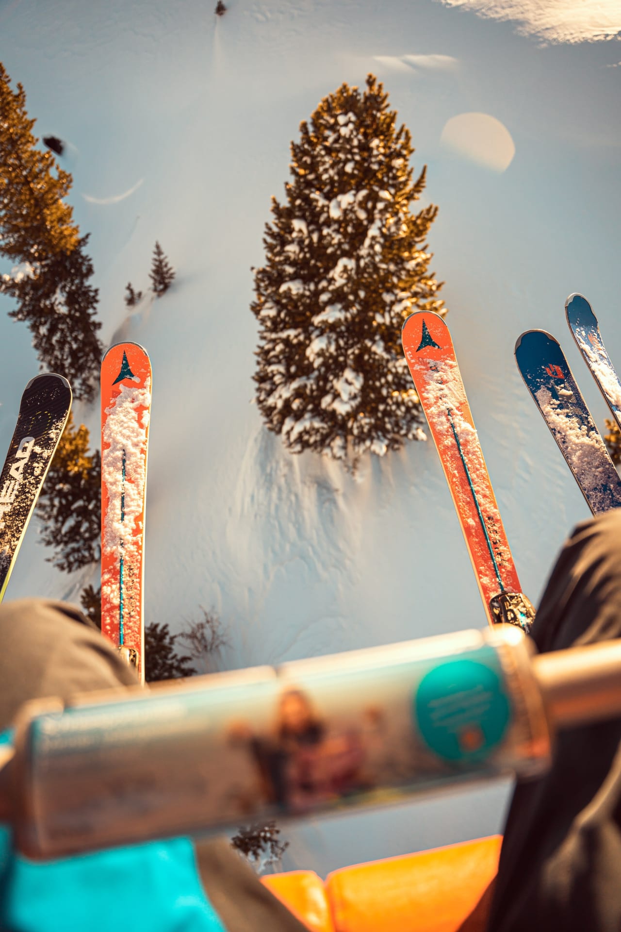 A group of people riding a chairlift up a snowy mountain.