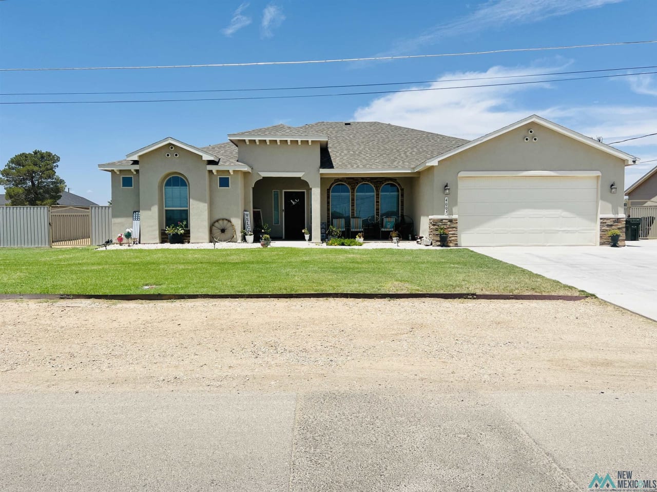 A large white house with a garage and a driveway.