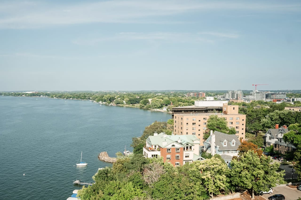 An aerial view of a calm lake surrounded by houses.