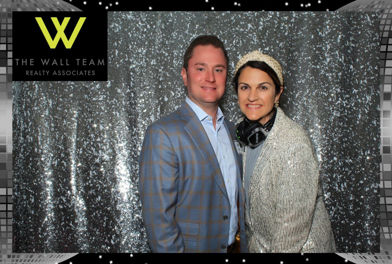 A man in a suit and a woman with a headband and a sparkling white suit