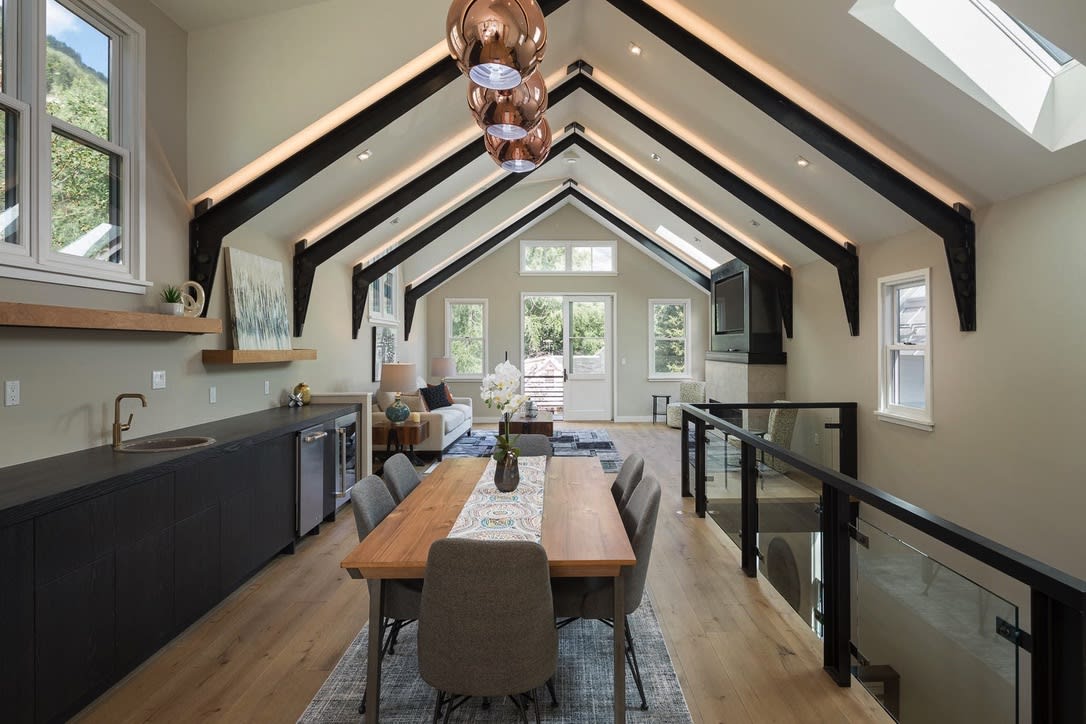 Luxury dining area with vaulted ceilings and exposed beams in Telluride home.