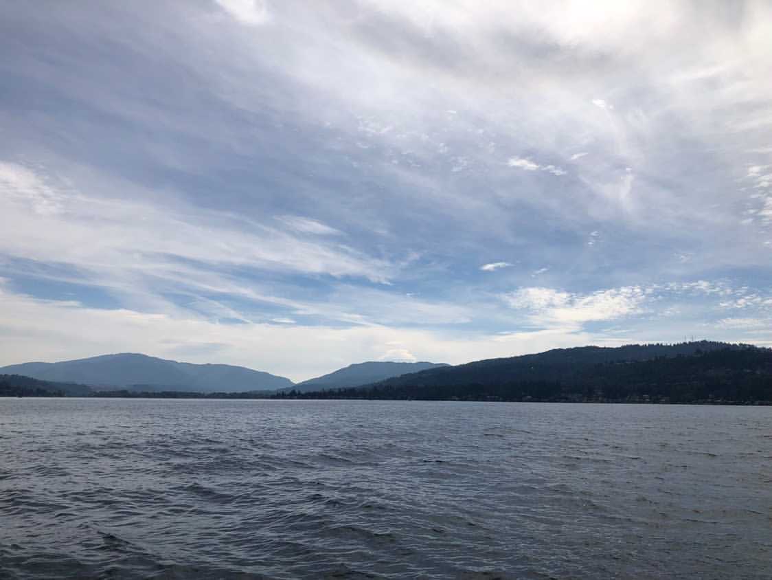 a calm lake with mountains in the background