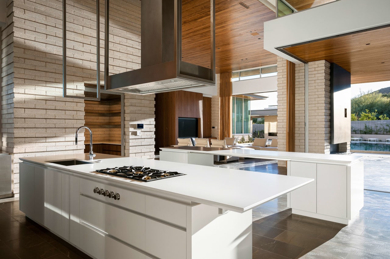 Modern kitchen with stone walls and millwork