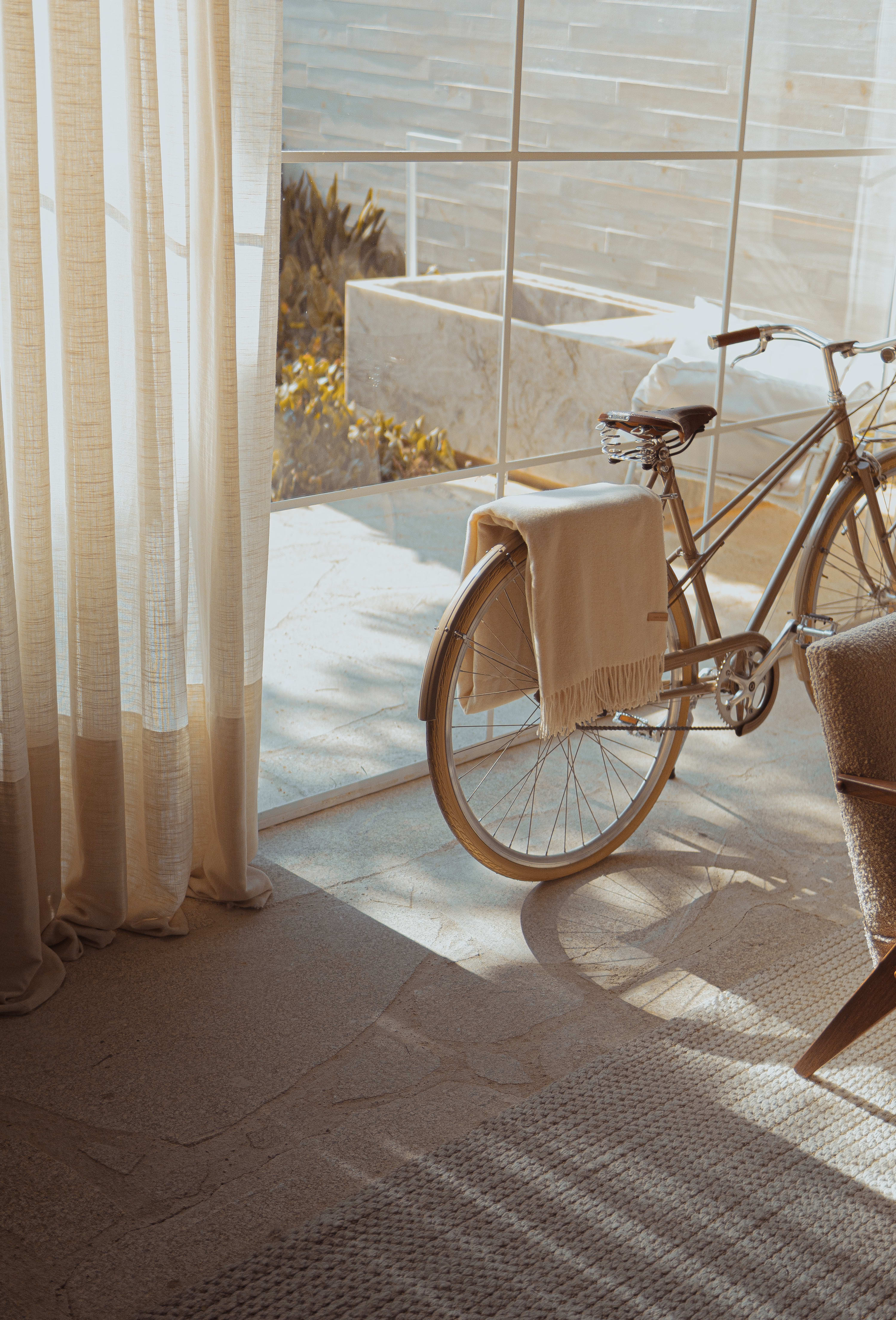 a bicycle parked near the glass window