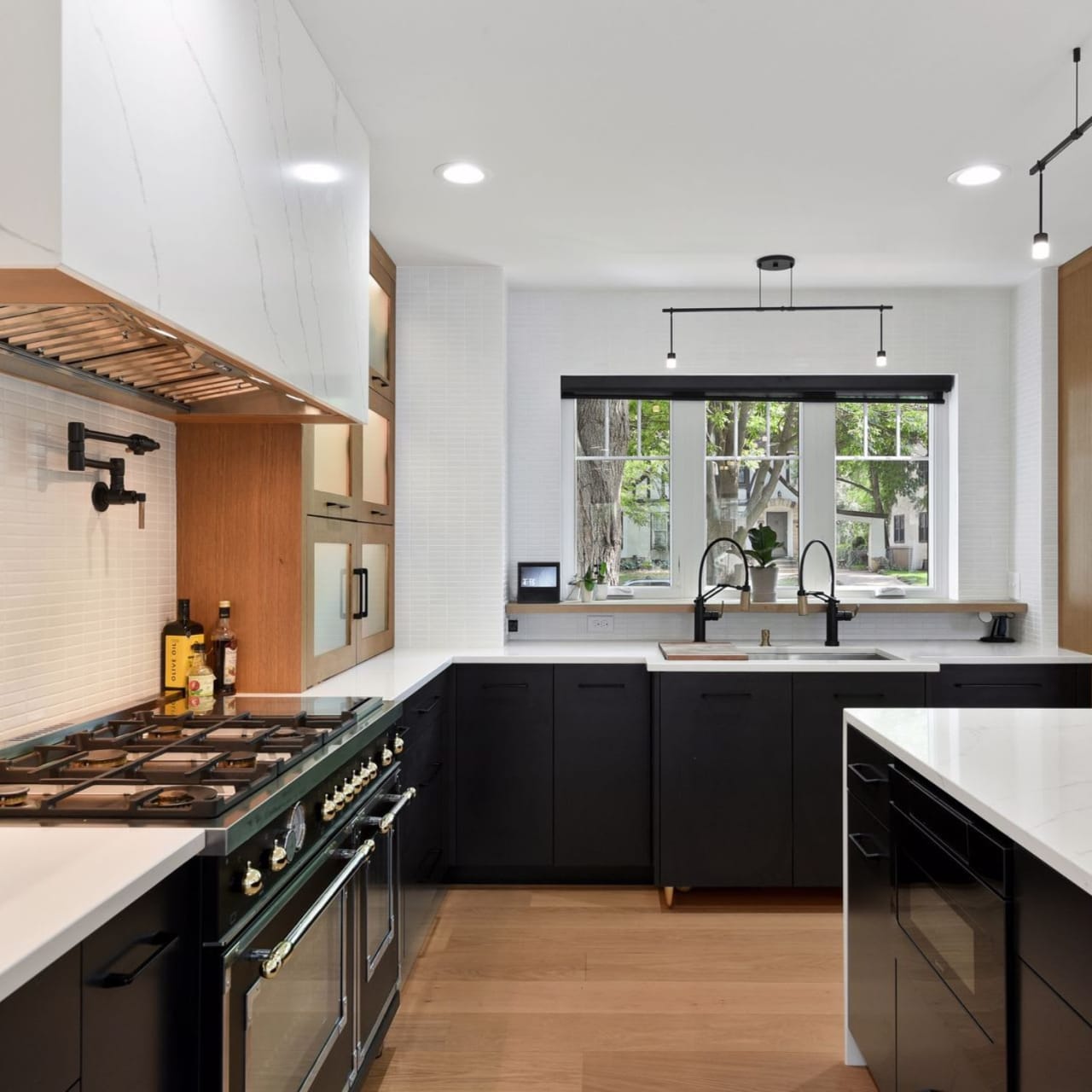 A kitchen with a sink and faucet and a kitchen island.