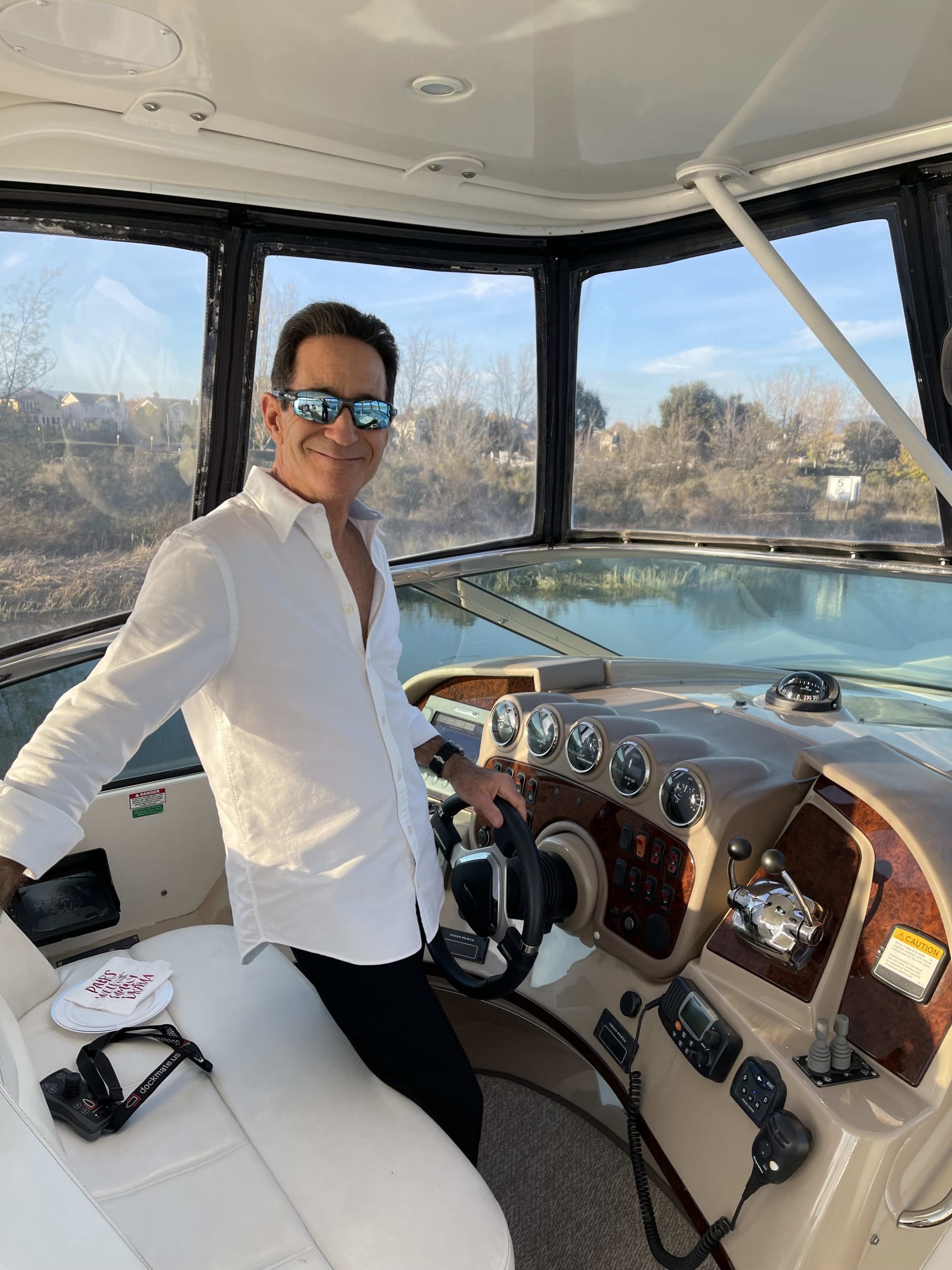 colored image of Avi Strugo inside a yatch holding the steering wheel