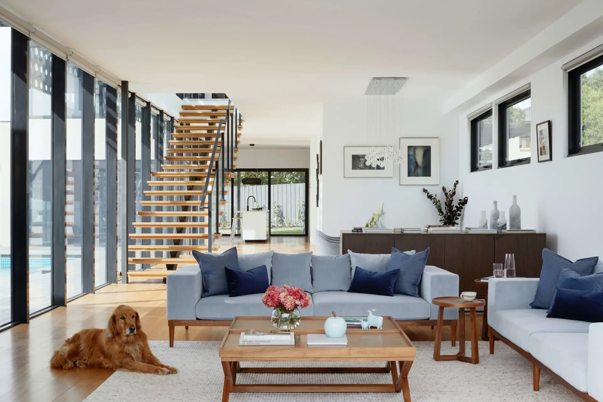 A bright and airy living room with a large sofa, two armchairs, and a coffee table