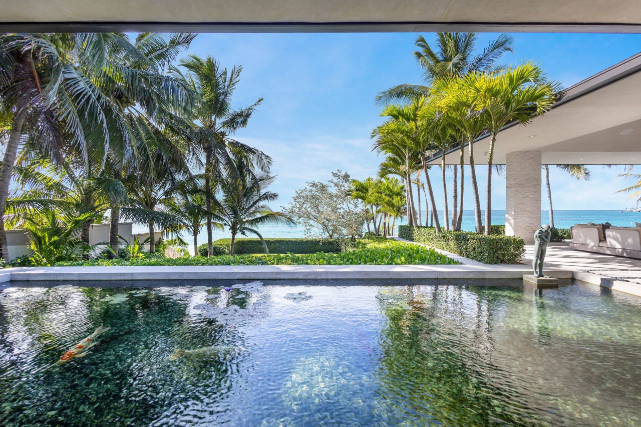 A large swimming pool with a blue liner and clear blue water.